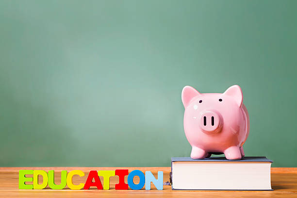 istock Education theme with textbooks and piggy bank 485779532