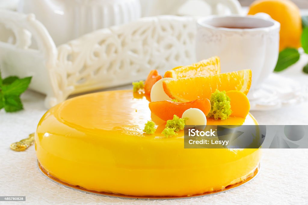 Cake with orange mousse and almond krokantom Cake with orange mousse and almond krokantom in the mirror glaze. Selective focus.Cake with orange mousse and almond krokantom in the mirror glaze. Selective focus. 2015 Stock Photo