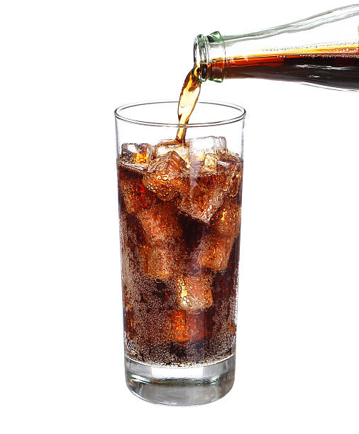 istock bottle pouring coke in drink glass with ice cubes Isolated 485787846