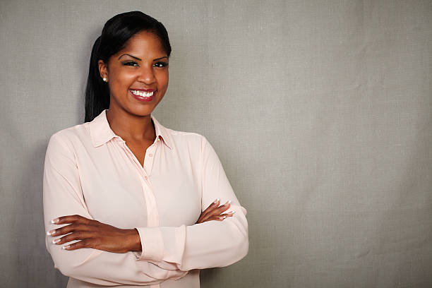 istock Charismatic female smiling with arms crossed 485788616
