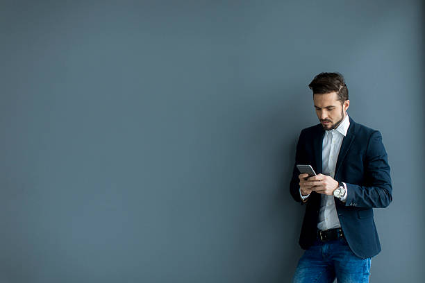 istock Young man with mobile phone in the office 485791684