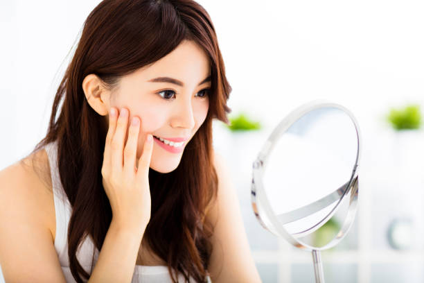 istock Happy young woman  looking on mirror 485792516