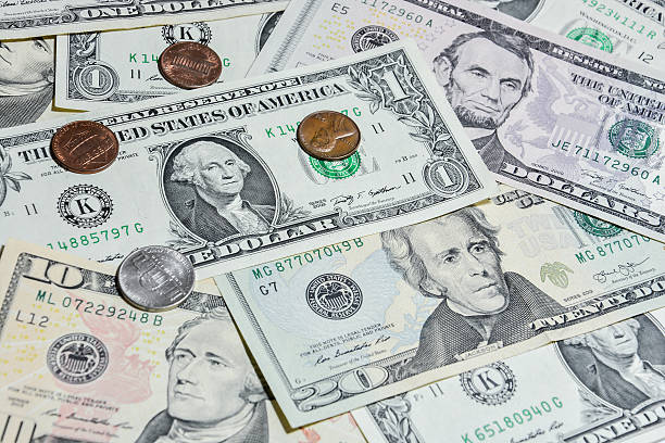 istock American Dollar bills with coins 485793958