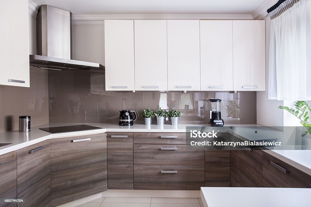Cozy beige kitchen Cozy beige kitchen interior with wooden cupboards Cabinet Stock Photo