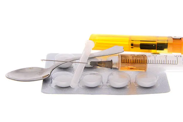 Addictions: syringe, drug, pills. Isolated on White Background.