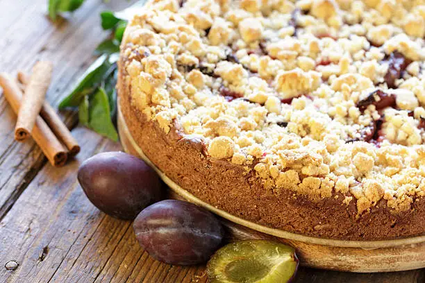 Plum cake on wooden board