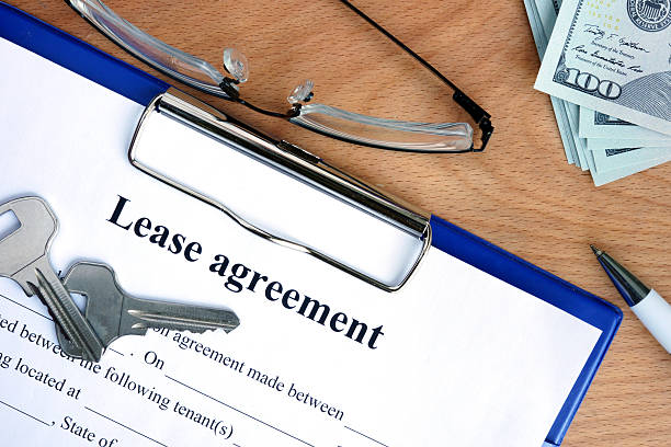 istock Lease agreement document with money on a wood background 485801952