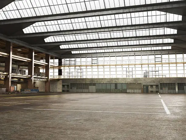 Photo of Large Interior grunge framed warehouse with an empty floor .