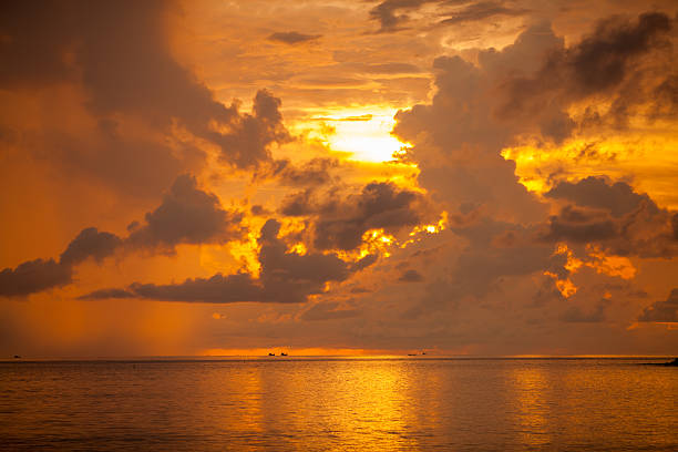 Silhouetted the beach at the sunset time.