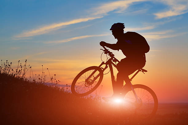 istock Silhouette of a biker and bicycle on sky background. 485805270