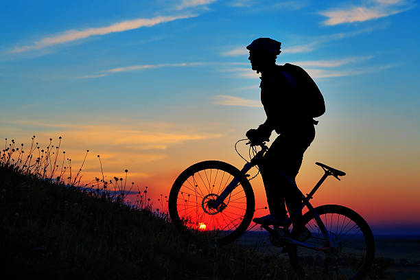 istock Silhouette of a biker and bicycle on sky background. 485806198