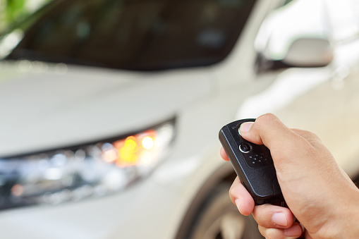 Hand holding button on the remote car.