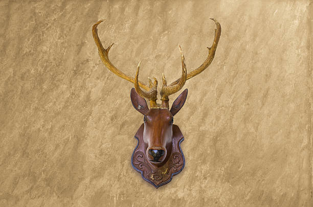 istock Deer head made of red wood on  concrete wall background. 485807078