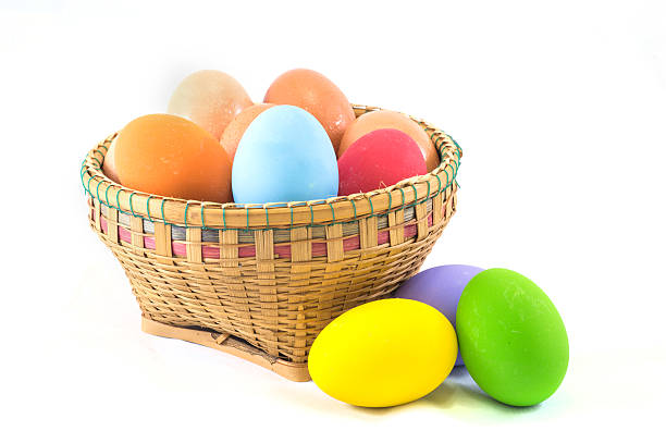 istock Close up of colorful eggs in a basket on white 485811690