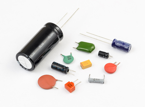 Various kinds of capacitors on white background