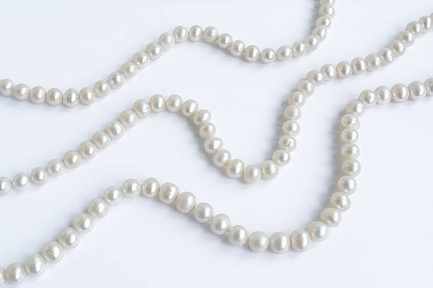 istock Abstract arranged three rows of natural pale pearl necklace 485814348