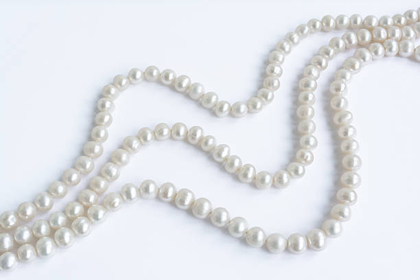 istock Abstract arranged three rows of natural pale pearl necklace 485814508