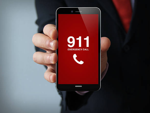 emergency call businessman smartphone emergency concept: businessman hand holding a 3d generated touch phone with emergency call on the screen. Screen graphics are made up. dialing stock pictures, royalty-free photos & images