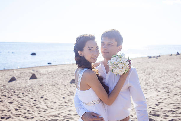 istock Just married happy couple running on a sandy beach 485815668