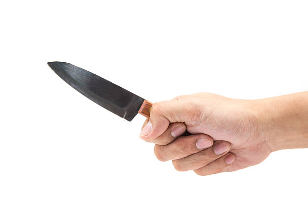 istock hand holding knife isolated on white background 485818464