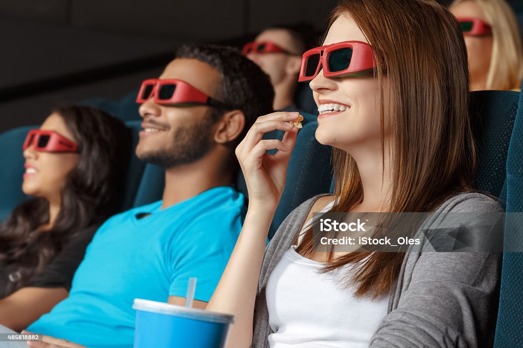 Friends watching 3D movie in the cinema 2015 Stock Photo