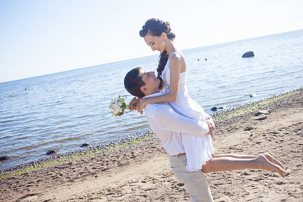 istock Just married happy couple running on a sandy beach 485819148