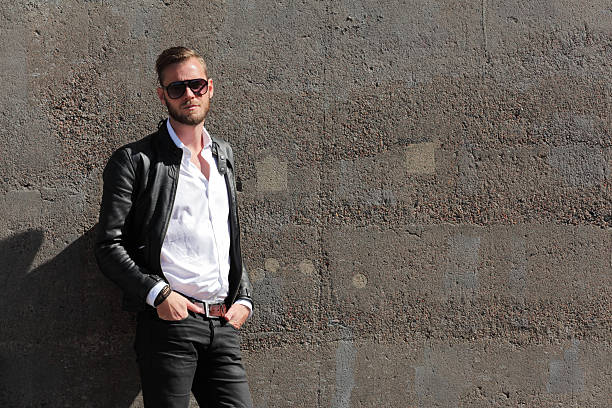 istock Handsome man leaning against a wall outside 485819174