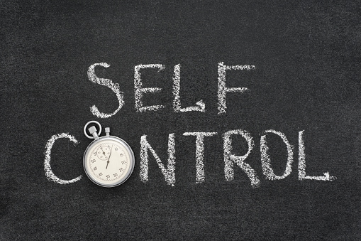 self control phrase handwritten on chalkboard with vintage precise stopwatch used instead of O