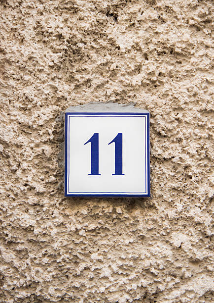 istock Number eleven on the stone wall 485823828