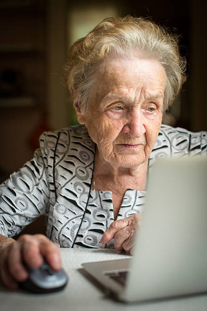 istock An elderly woman working on a laptop 485829074
