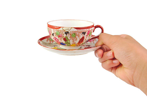 istock Hand with chinese cup of coffee isolated on a white 485829654