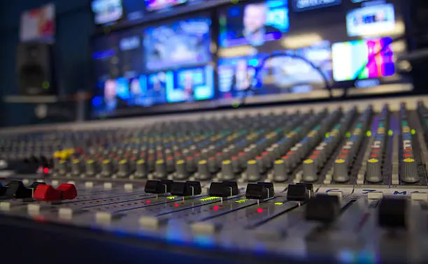 A multi channel audio mixer on a television station with shallow depth of field.