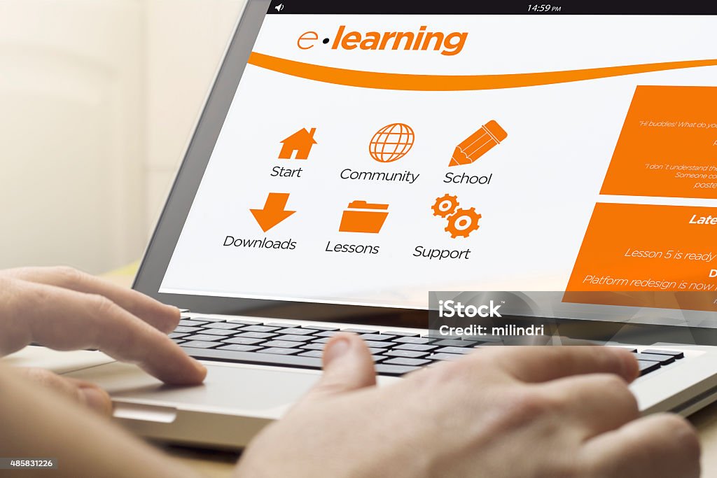 home computing e-learning online training concept: man using a laptop with e-learning platform on the screen. Screen graphics are made up. E-Learning Stock Photo