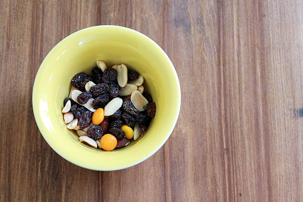 istock Yellow bowl of trail mix with raisins, nuts 485832306