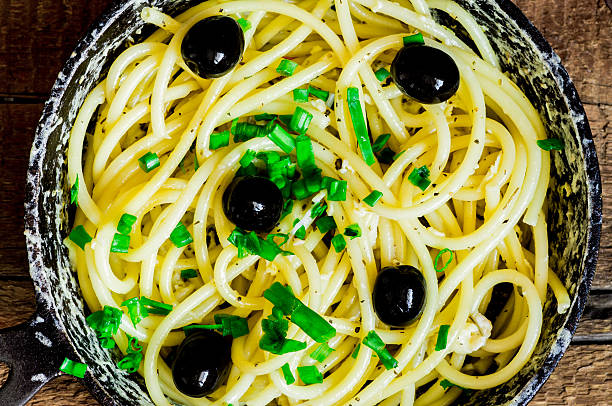 Bucatini pasta with egg and leek and olives
