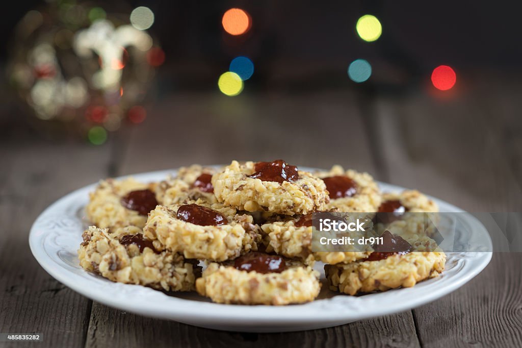 cookies with jam on a plate Christmas cookies with walnuts and jam on a creative plate. Xmas background 2015 Stock Photo