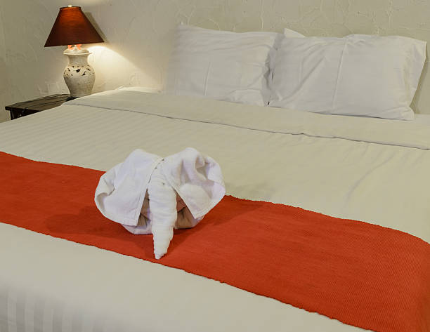 istock White towel in form of elephant on bed 485836200