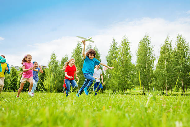 istock View of fast moving boy holding white airplane toy 485836698