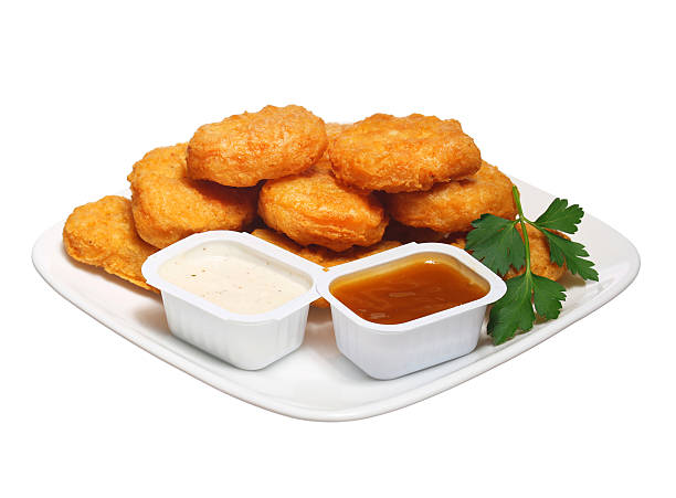 istock Chicken nuggets in plate with two dressings isolated 485839770