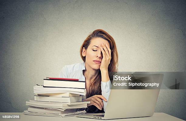 Tired Sleepy Woman Sitting At Desk With Books And Computer Stock Photo - Download Image Now