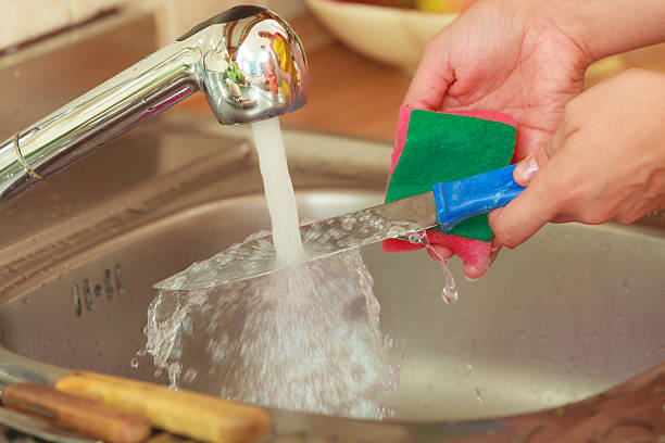 istock Woman doing the washing up in kitchen 485843630
