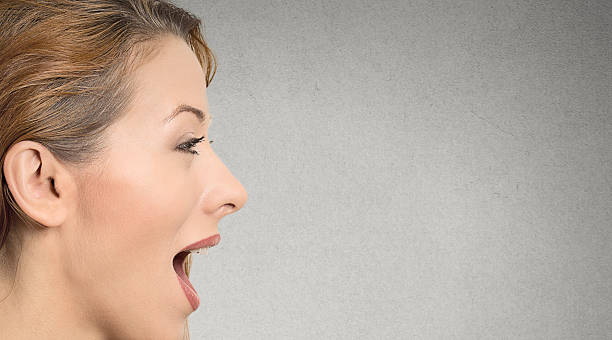 istock woman with open mouth talking 485845050