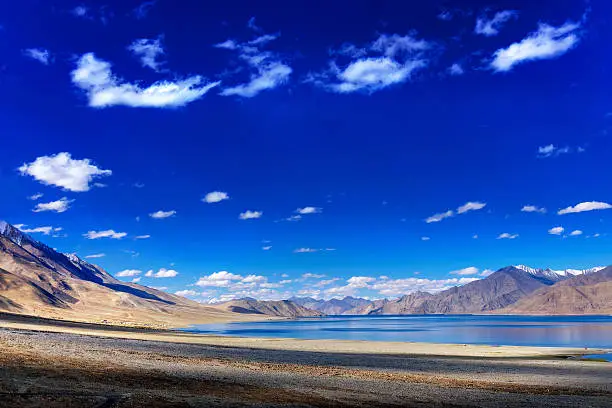 Beautiful blue sky, clouds and mountains at Pangong tso (Lake). It is huge lake in Ladakh, extends from India to Tibet. Leh, Ladakh, Jammu and Kashmir, India. Travellers paradise.