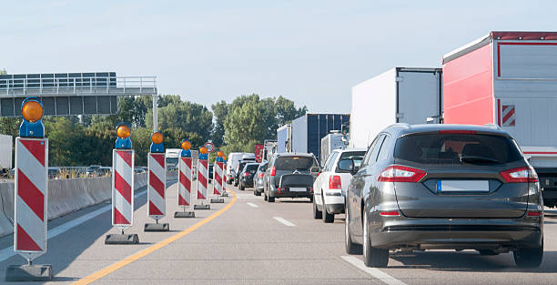 istock freeway with building lot and traffic jam 485849922