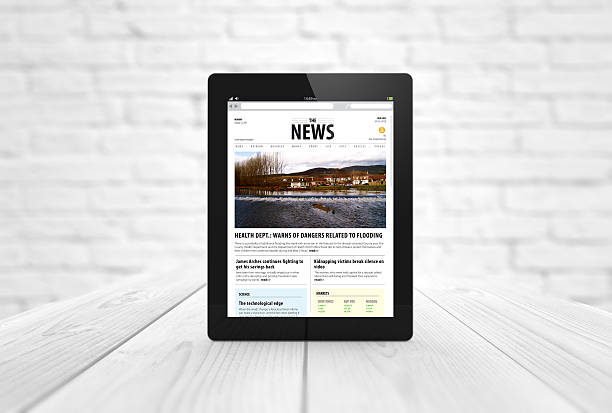 istock news tablet on wooden table 485850340