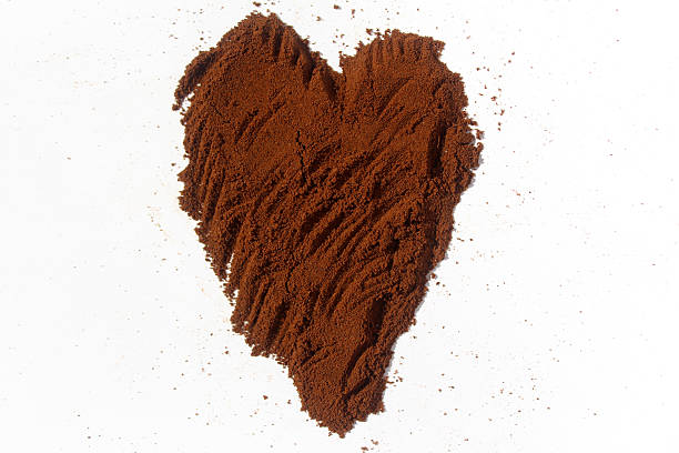 istock Ground coffee in shape of heart isolated on white 485850420