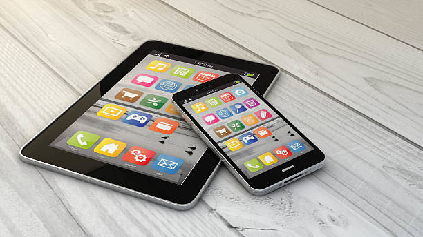 istock tablet and phone over wooden floor 485850702