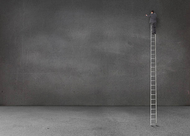 istock Businessman standing on a giant ladder in an empty room 485850801