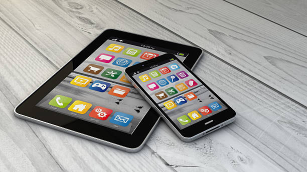 istock tablet and phone over wooden floor 485851166