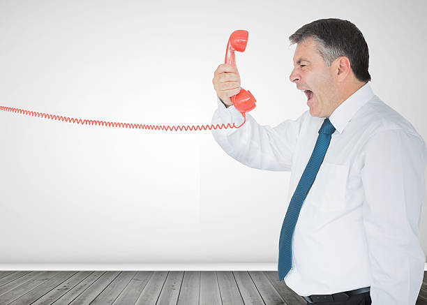 istock Businessman holding a phone and screaming 485851247
